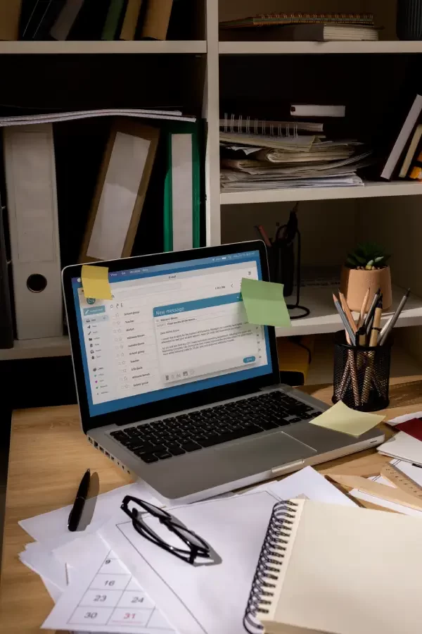 view-office-desk-with-messy-workspace-laptop